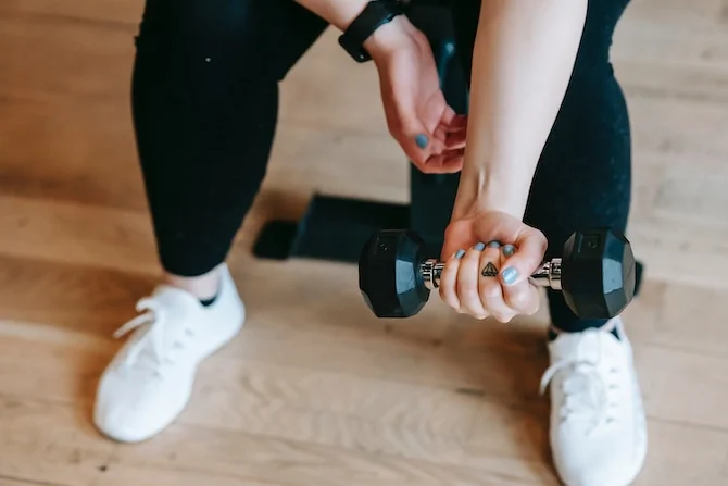 Woman at gym lifting small weight