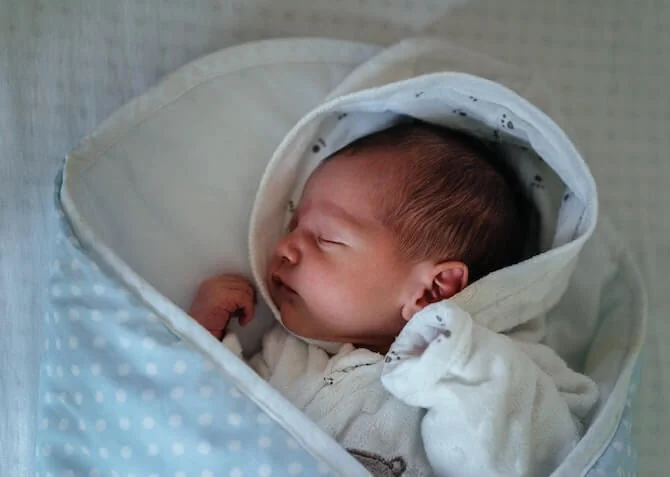 baby sleeping in a swaddle
