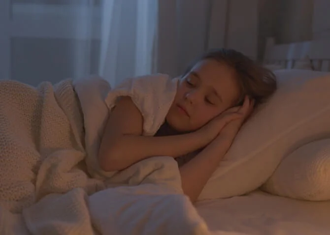 kid sleeping well on a comfy bed