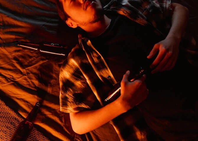 drunk man asleep in bed