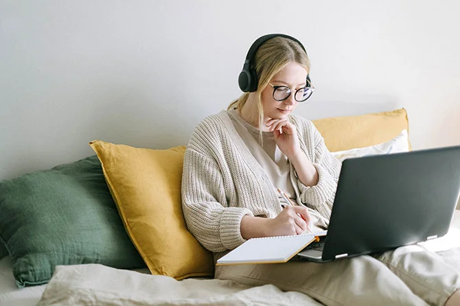 Student studying on bed